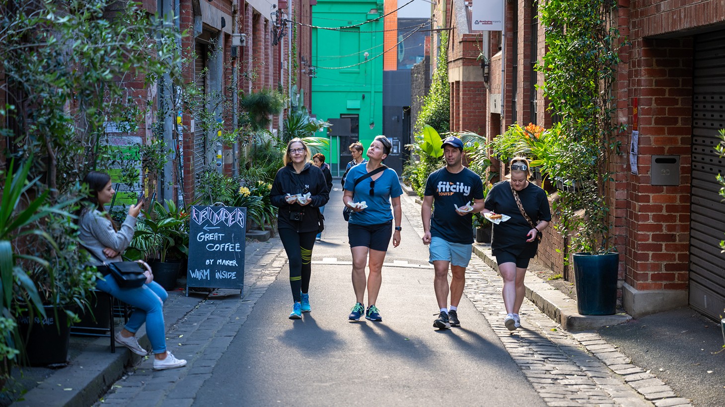 Guided walking tour group exploring a Melbourne laneway