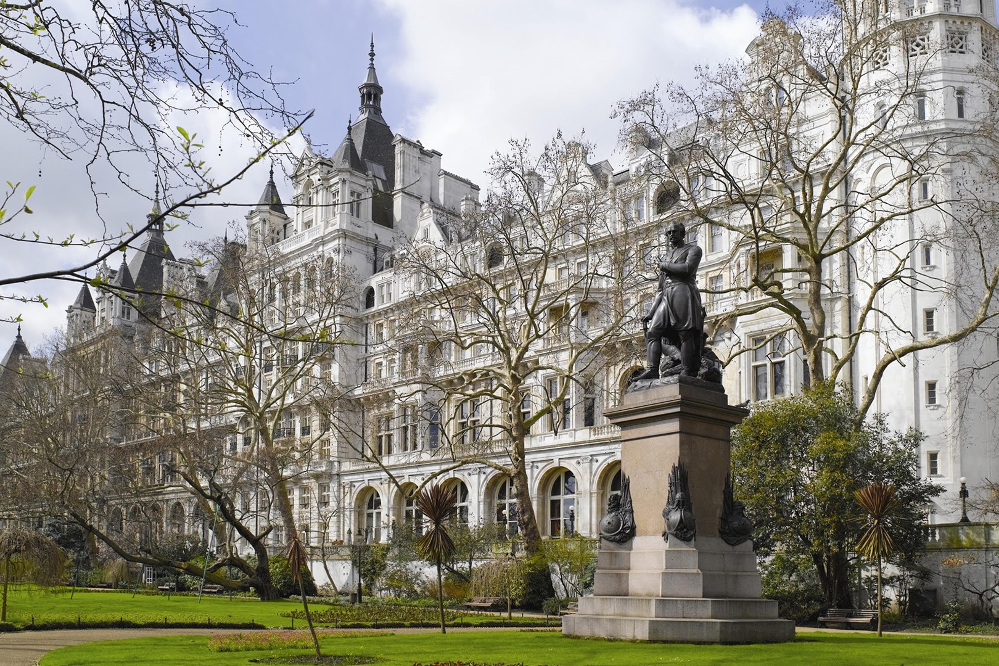 Victorian-era The Royal Horseguards hotel on the River Thames with historic architecture.