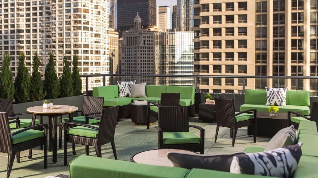 Outdoor sundeck with seating offering city views in Chicago hotel.