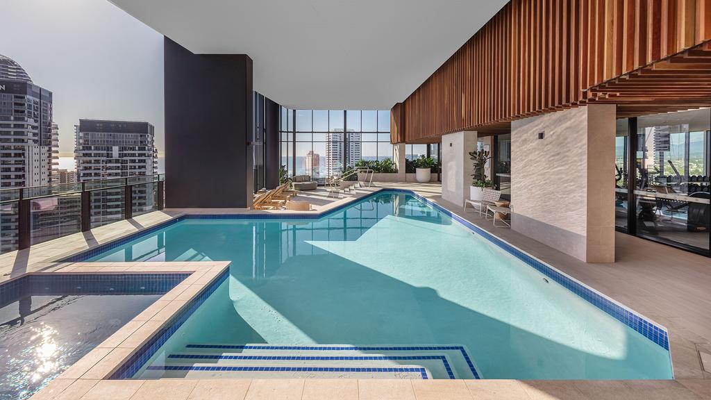 Luxurious resort-style pool with city views at Broadbeach apartments. 