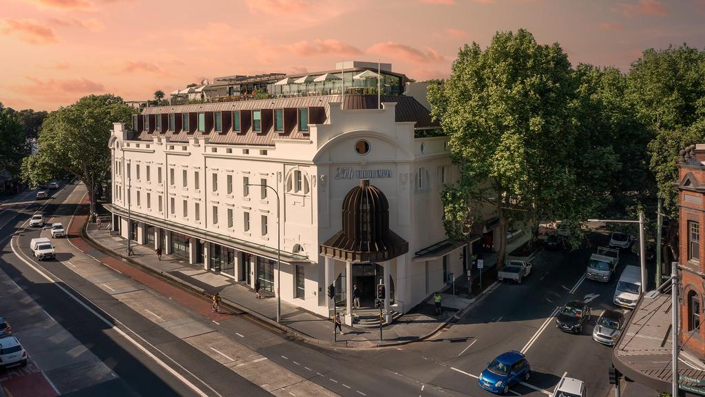 Exterior of 25hours Hotel The Olympia Sydney on a sunny street corner.