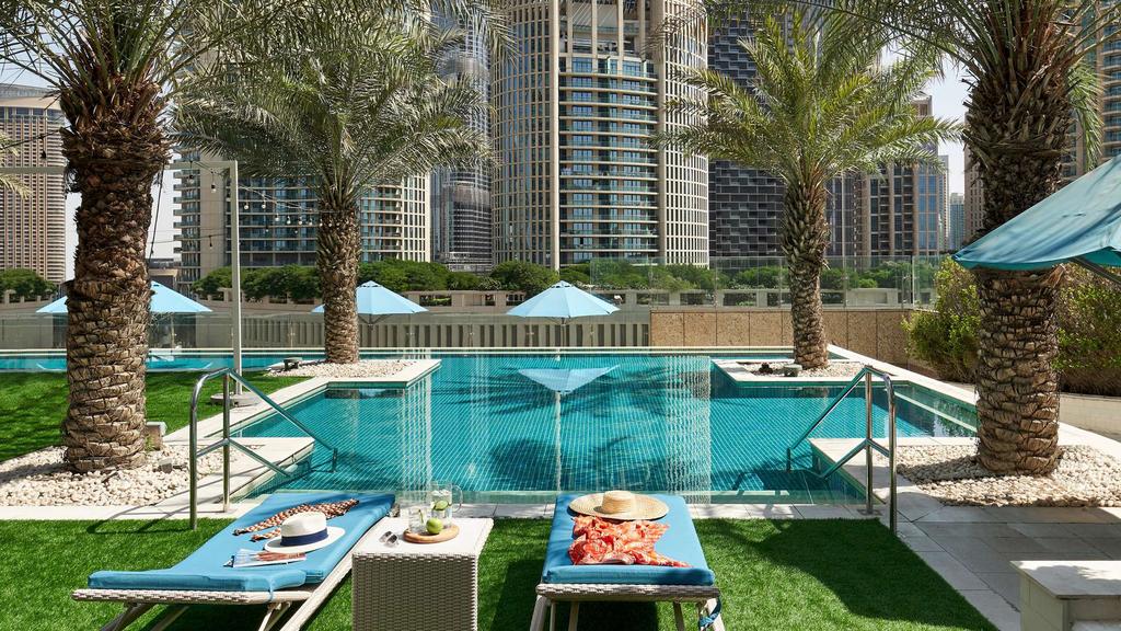 Rooftop infinity pool with city skyline view in downtown Dubai.