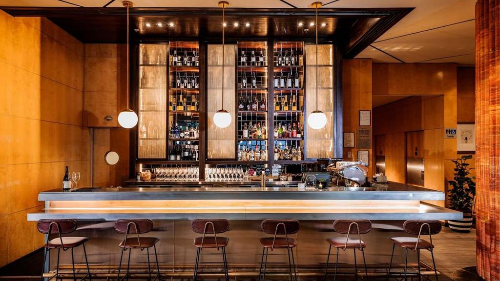 Elegant bar area at Amora Hotel Jamison Sydney with stool seating.