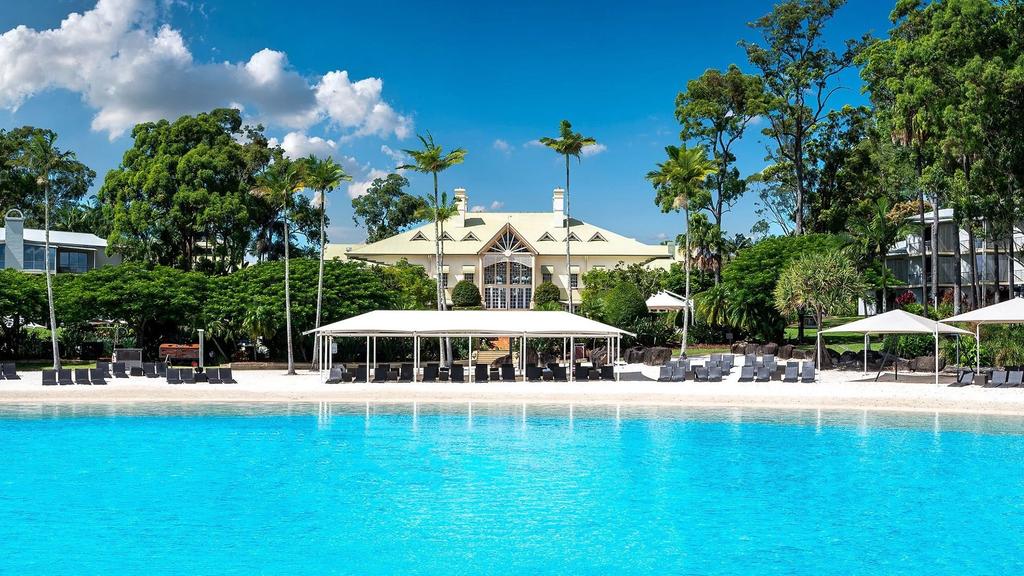 A luxurious lagoon pool at InterContinental Sanctuary Cove Resort, an IHG Hotel with tropical gardens. 