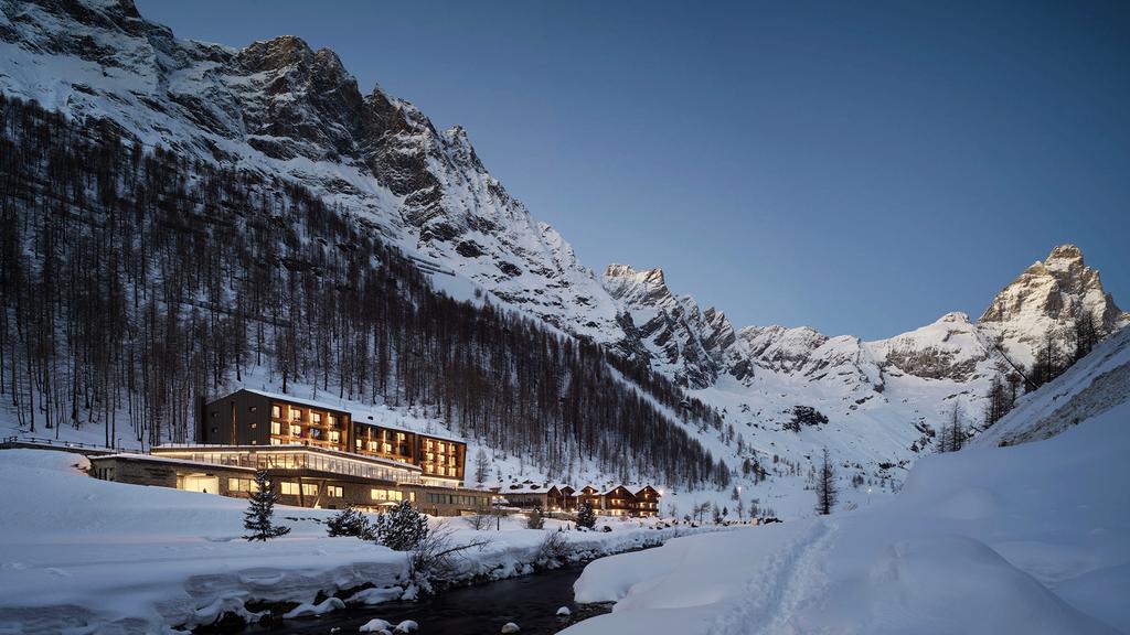 Italian Alpine retreat with snow-capped peaks and luxurious amenities.
