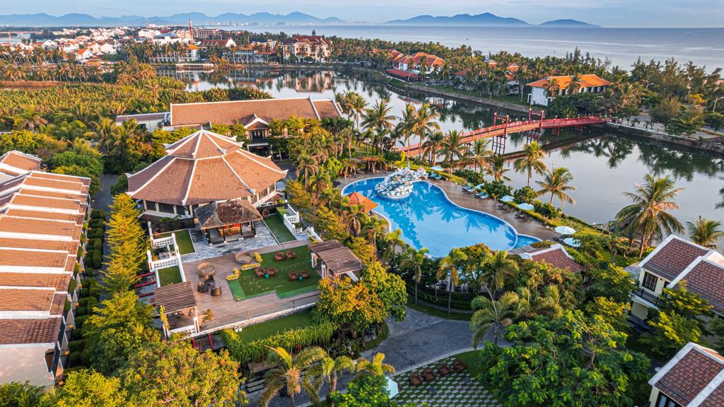 Aerial view of KOI Resort & Spa Hoi An by the river.