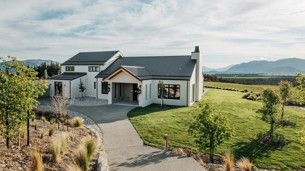 Luxury estate overlooking Lake Pukaki and mountain range in New Zealand.