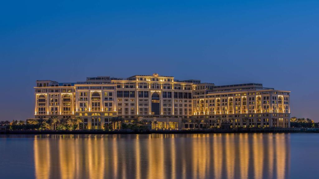 Waterfront view of Palazzo Versace Dubai at night.