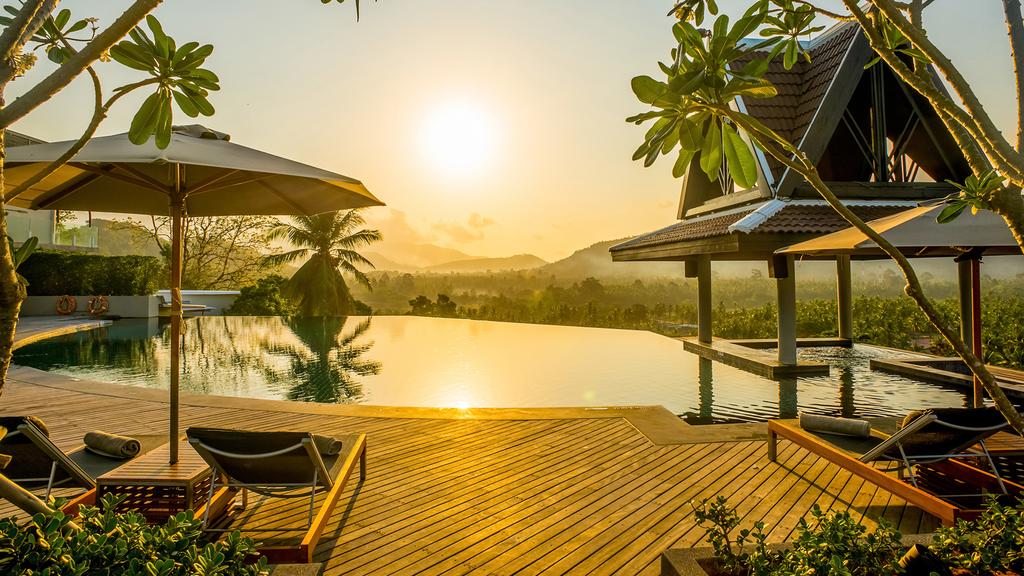 Infinity pool at sunset in Koh Samui five-star resort.