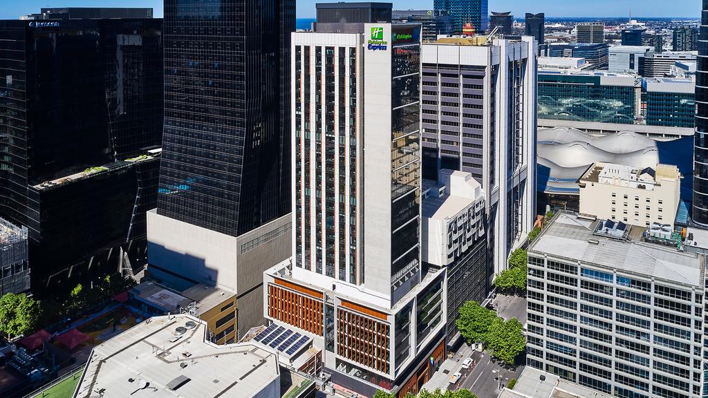 Aerial view of Holiday Inn Express in Melbourne's vibrant cityscape.