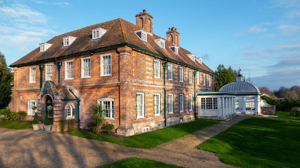Historic manor house with classic architecture and lush grounds.