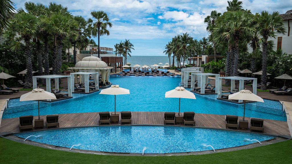 Luxurious pool area at a beachfront resort in Hua Hin, Thailand.