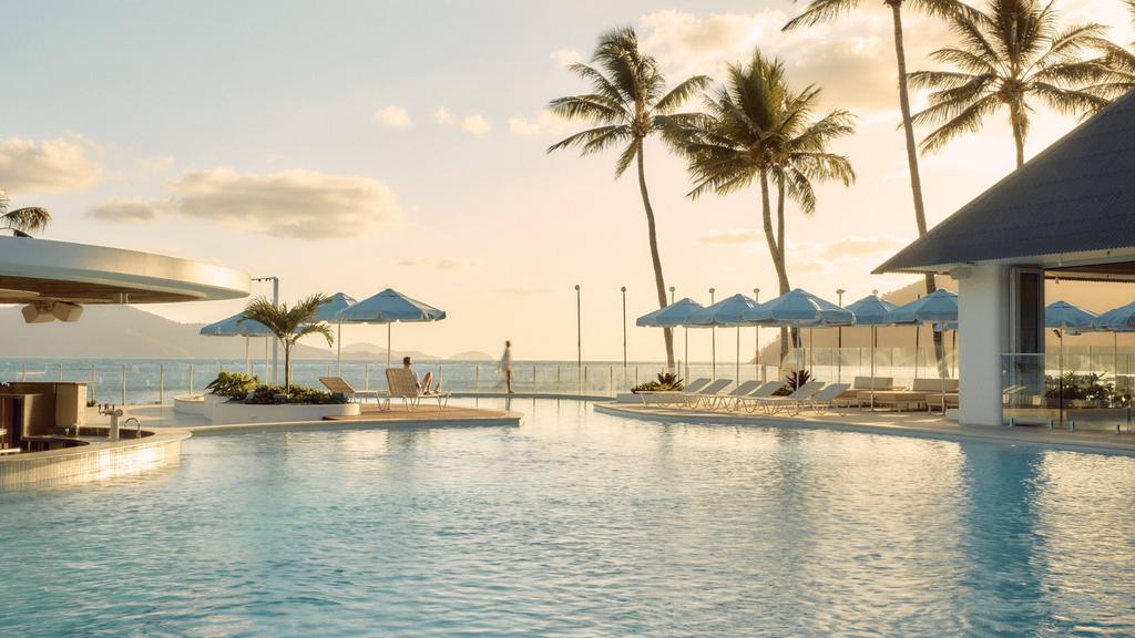 Pool with loungers and palm trees on Hamilton Island