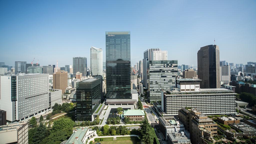 Aerial view of The Okura Tokyo hotel amidst city skyscrapers.