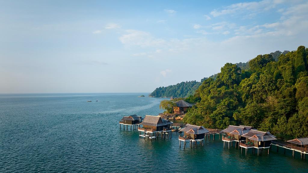 Overwater villas at lush private island Pangkor Laut Resort in Malaysia.