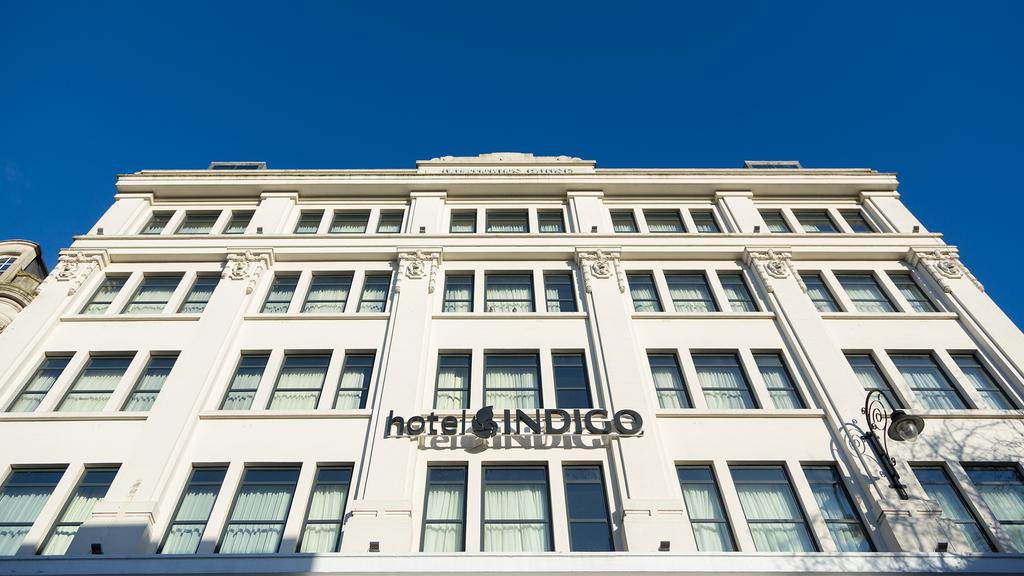 Exterior view of Hotel Indigo Cardiff with clean white facade.