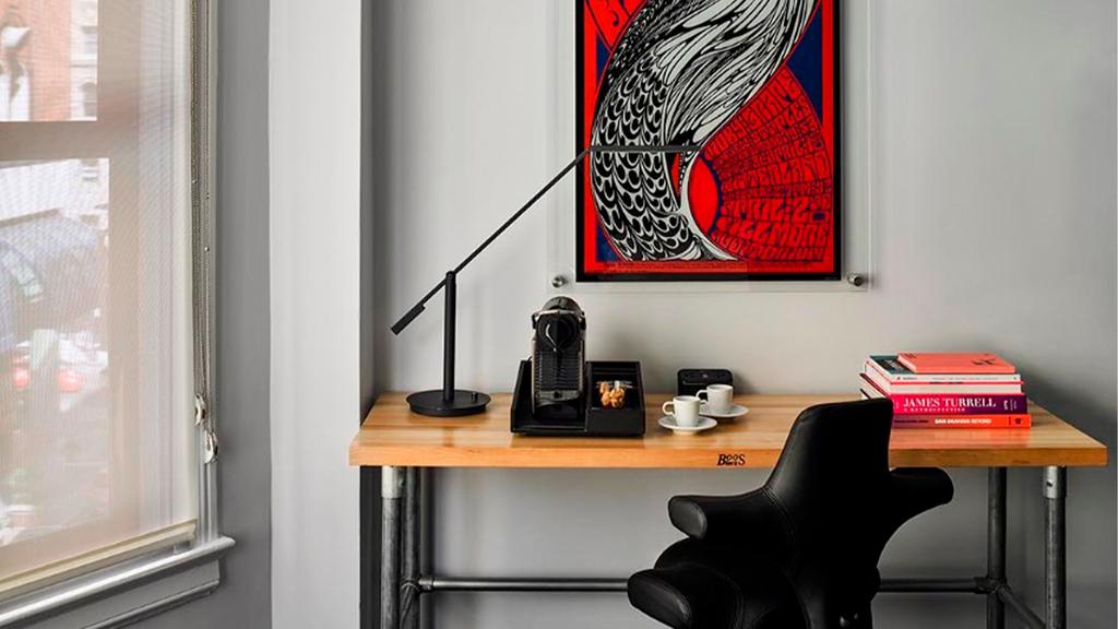 Stylish desk setup at Hotel Zeppelin with art and coffee maker.