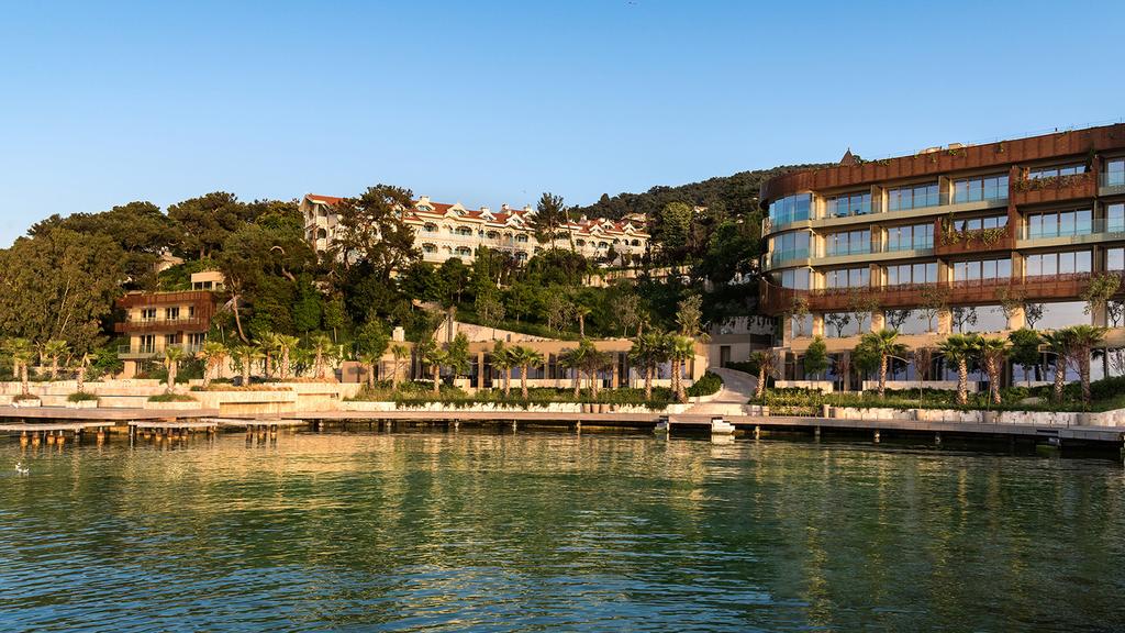 Luxury resort on Buyukada Island with waterfront view and lush greenery.