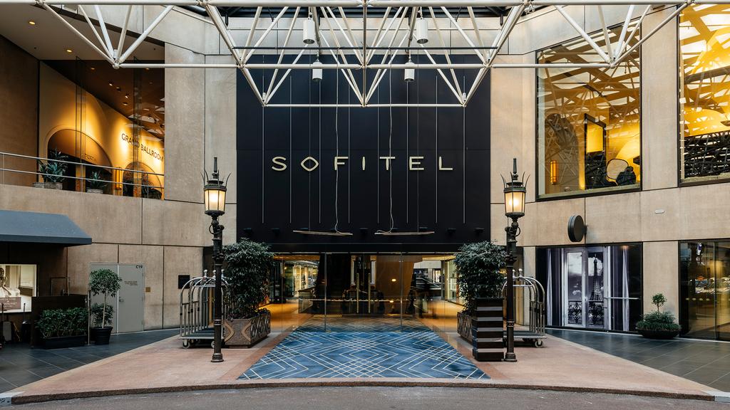 Entrance of Sofitel Melbourne with elegant design and signage.