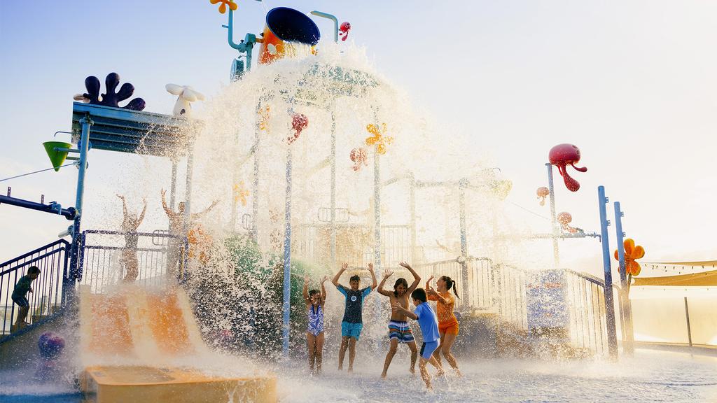 Children playing under water features at Sea World Resort's aqua play area.