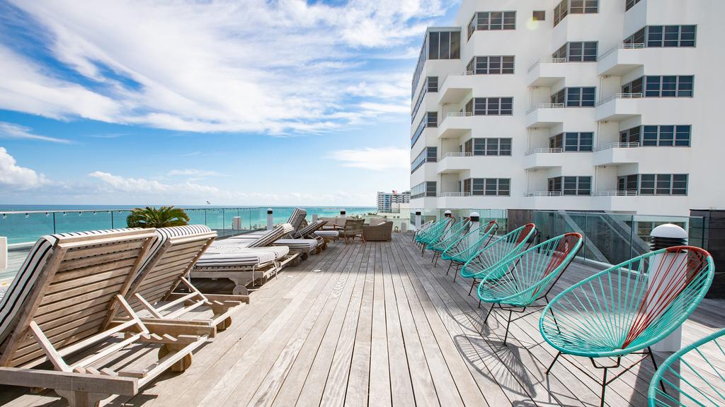 Oceanfront terrace at Nautilus Sonesta Miami Beach with lounge chairs and ocean view.