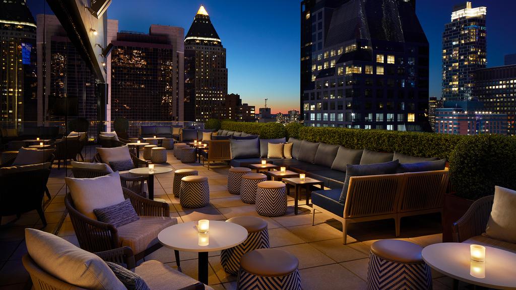 Rooftop bar at Hard Rock Hotel New York with nighttime city views.