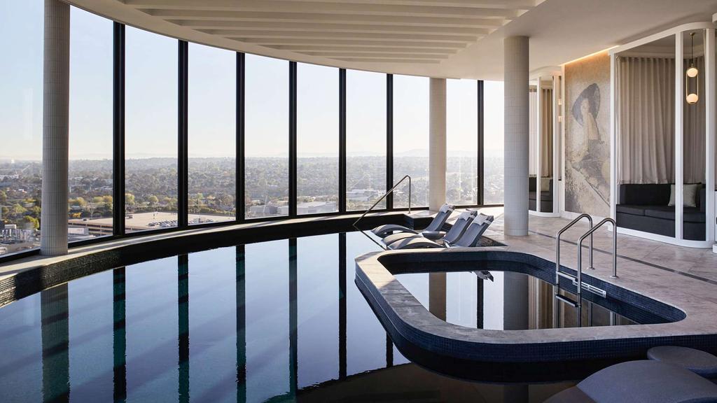 Curved rooftop pool with skyline views at Hotel Chadstone Melbourne.