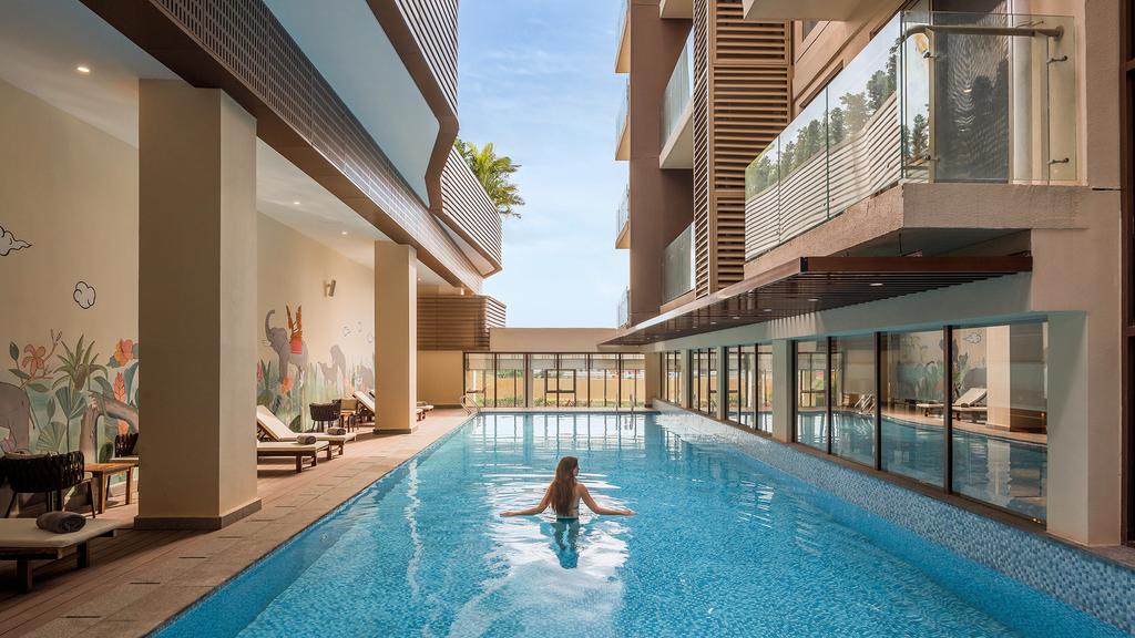 Guest swimming in a luxurious hotel pool in Phnom Penh.