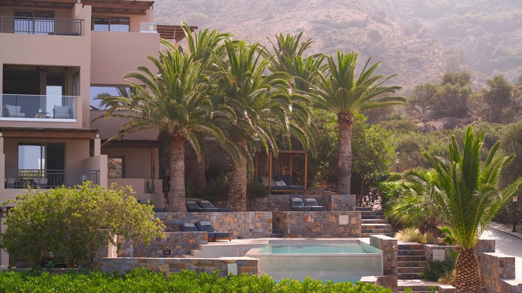 Pool with palm trees at Paralos Irini Mare