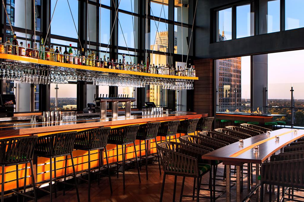 Rooftop bar at Kimpton Tryon Park Hotel with city skyline views.
