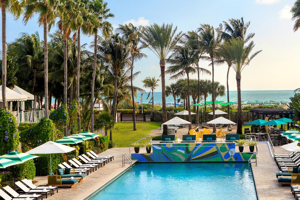Tropical beachfront pool at Kimpton Surfcomber Hotel in South Beach, Miami.
