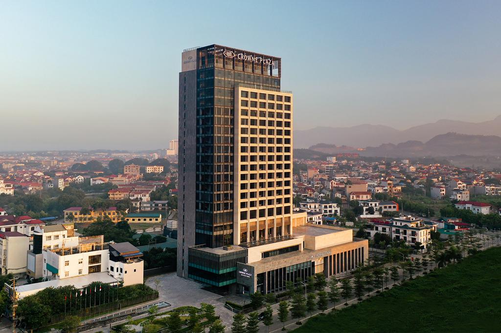 Exterior view of Crowne Plaza Vinh Yen surrounded by the cityscape.