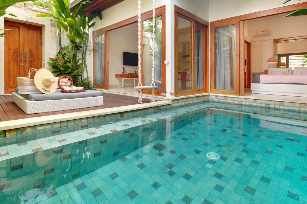 Private Bali retreat with pool and tropical garden view at The Jimbaran Villa.