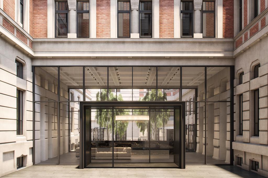 Exterior view of Kozmo Hotel Budapest with modern glass entrance.