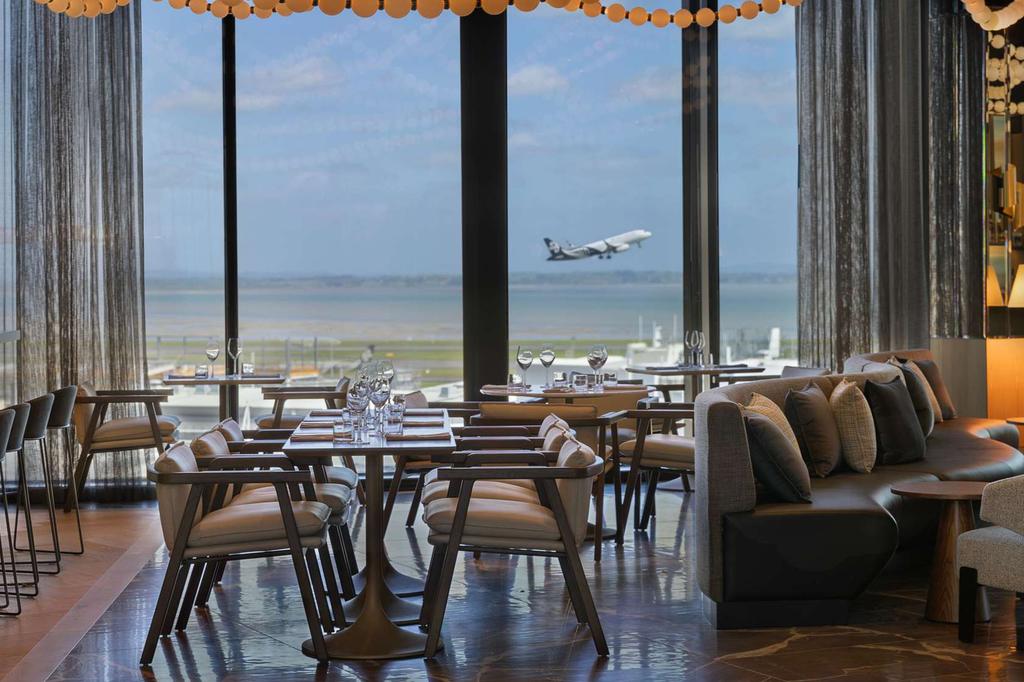 Te Kaahu Restaurant at Pullman Auckland with airport runway view.