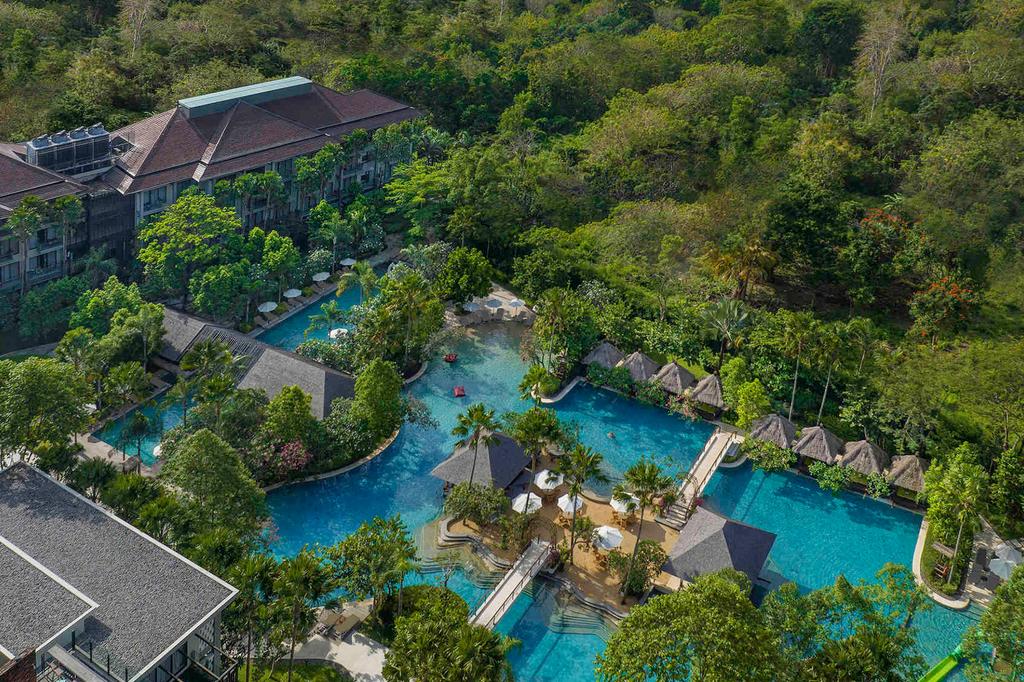 Aerial view of a lush resort with expansive pools in Bali.