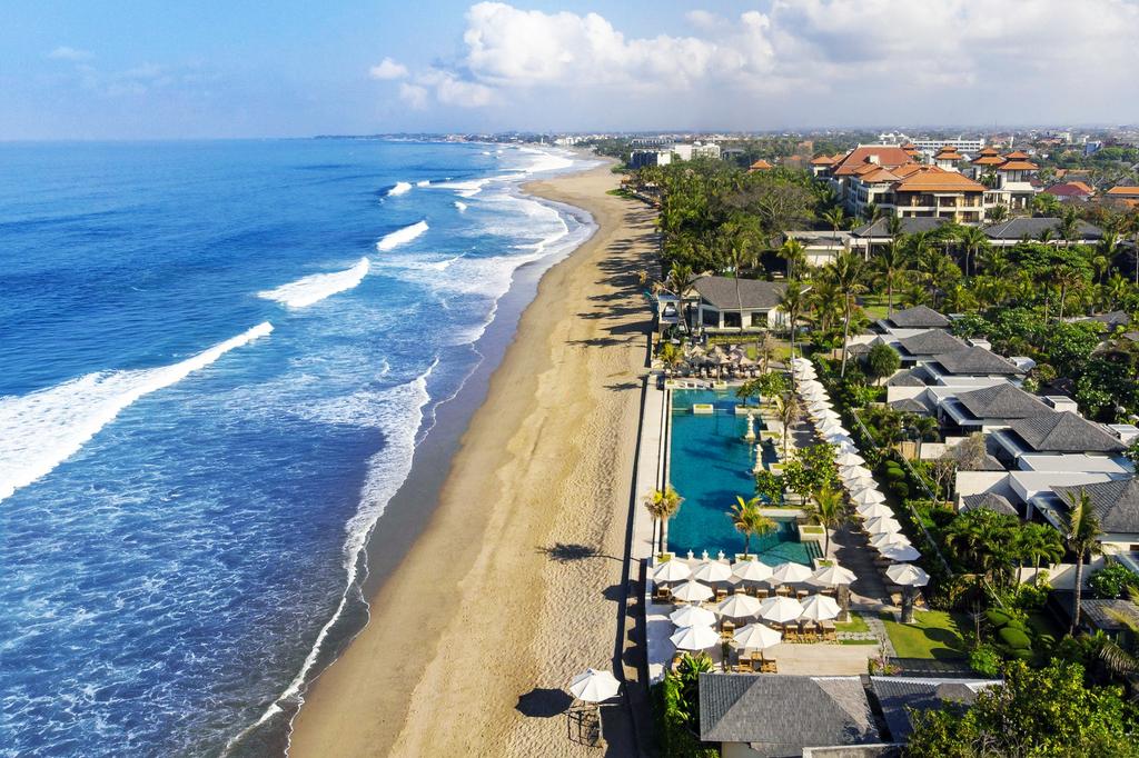 Aerial view of a luxurious beachfront resort in Seminyak, Bali.