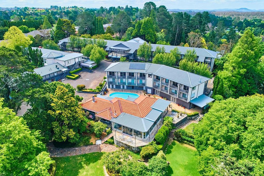 Aerial view of a Blue Mountains retreat with an outdoor pool and gardens.