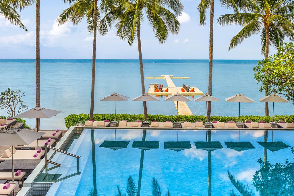 Infinity pool overlooking the ocean at a luxury beachfront resort.