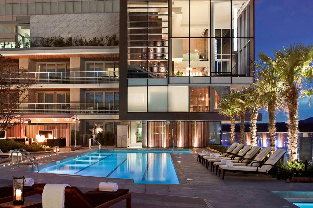 Luxurious rooftop pool at a Vancouver harbourfront hotel with city views.