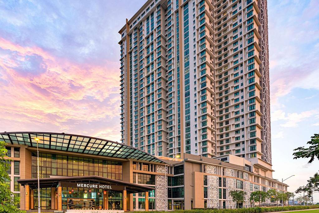 Modern high-rise apartments at Mercure Living Putrajaya during sunset.