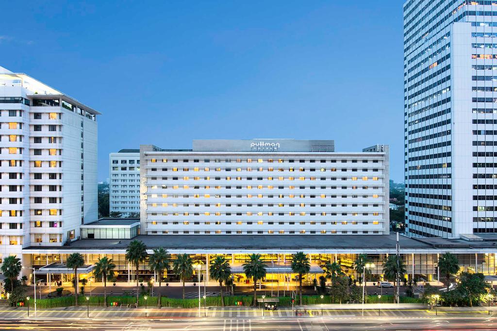 Exterior view of Pullman Jakarta Thamrin CBD at dusk.