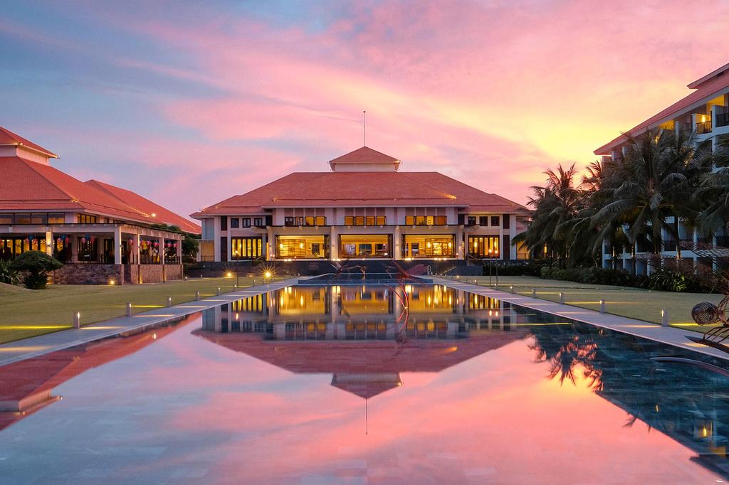 Pullman Danang Beach Resort with sunset reflection in the pool.