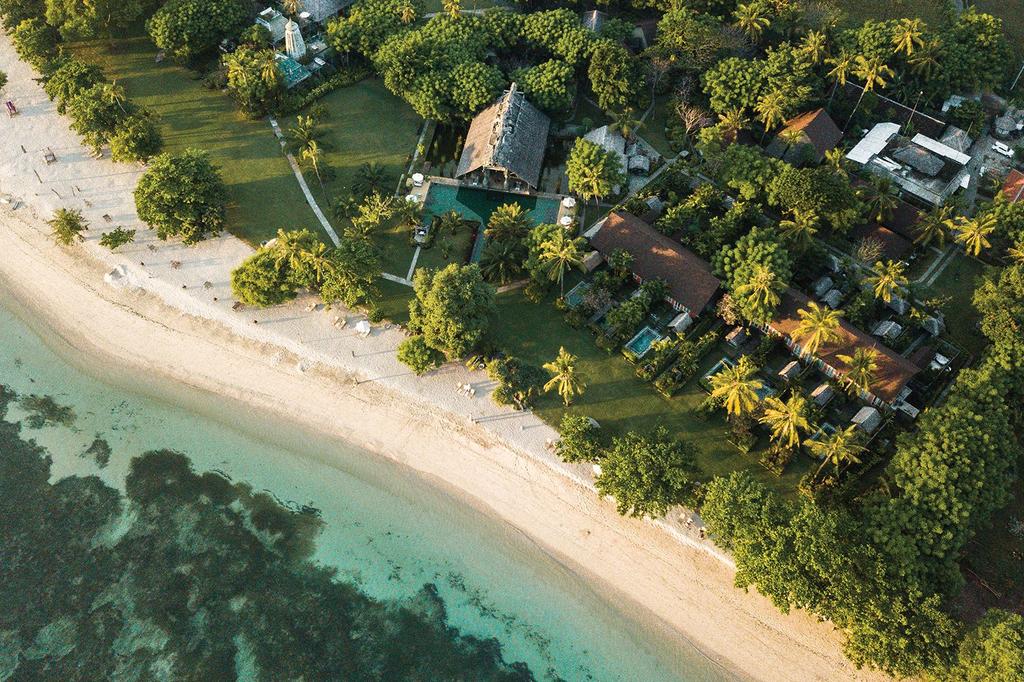 Aerial view of Hotel Tugu Lombok on Sire Beach with lush greenery.