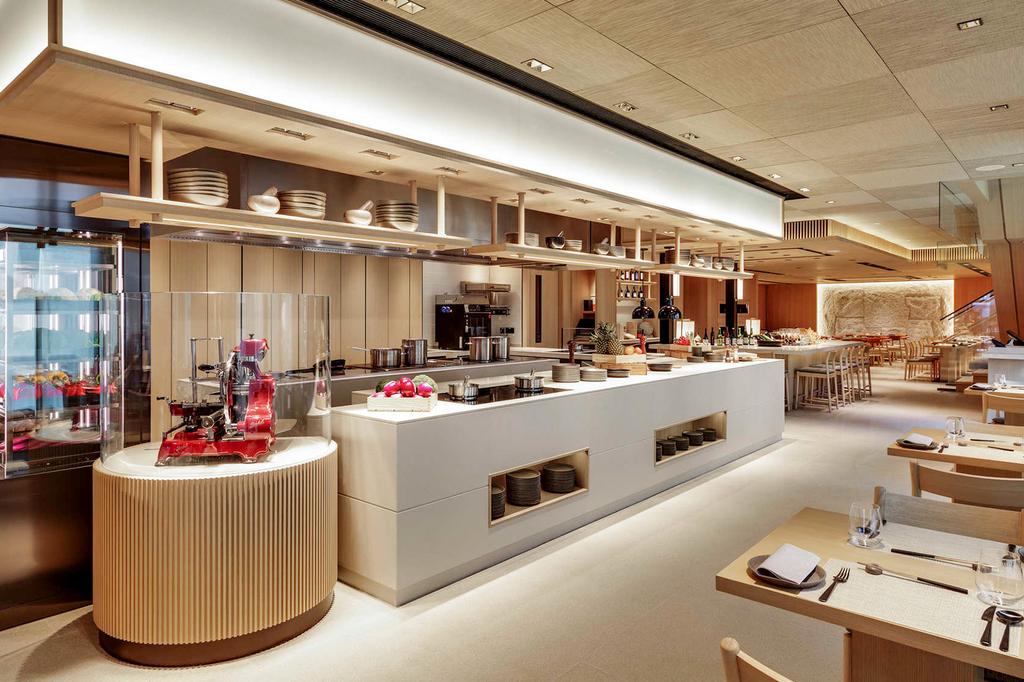 Modern restaurant interior with warm wood accents and elegant dining setup.