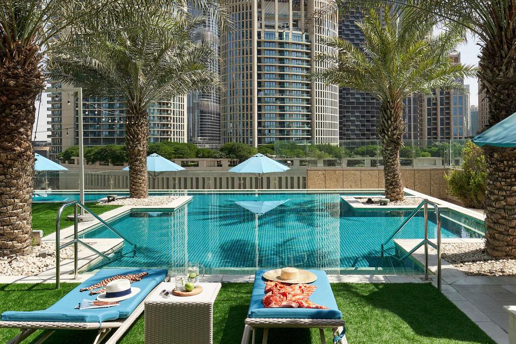 Rooftop infinity pool with city skyline view in downtown Dubai.