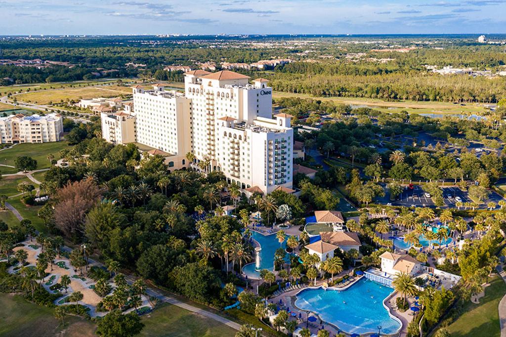 Aerial view of a luxury resort in Orlando with pools and golf courses.