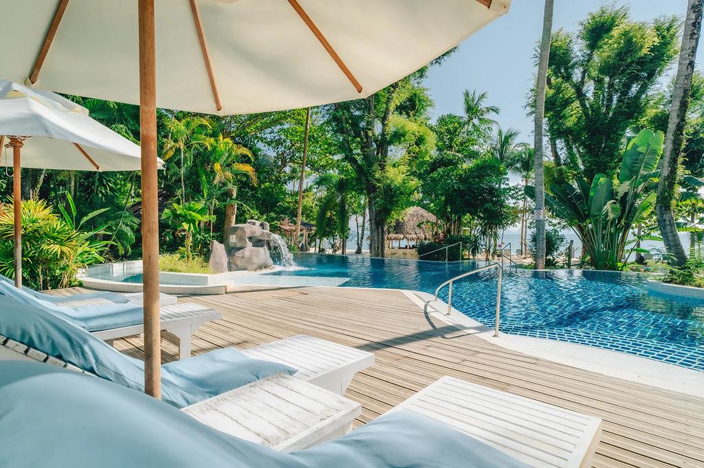 Secluded poolside at a boutique island resort in Koh Yao Noi, Thailand. 