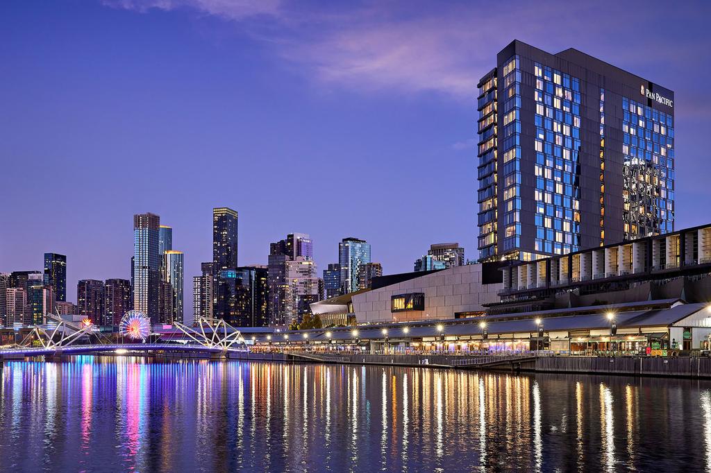Pan Pacific Melbourne hotel by the Yarra River at dusk.  