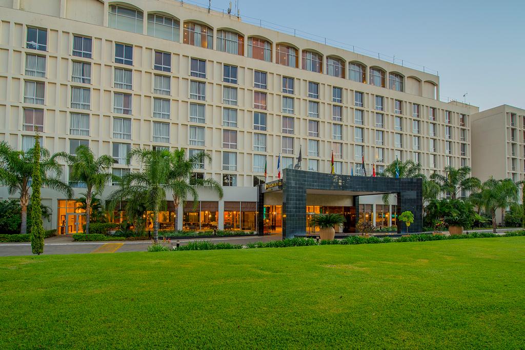 Modern hotel exterior with greenery in Lusaka's embassy district.